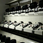 Industrial yarn winding and preparation machines in knitwear factory with rows of yarn cones
