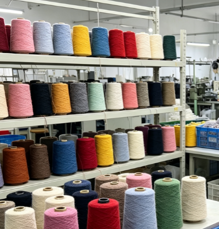Various color yarn cones for custom sweater manufacturing, raw material preparation per client request