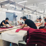 Finishing team doing thread trimming, steam ironing, and final check for completed knit sweaters