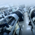 Advanced computerized flat knitting machines operating in knitwear manufacturing facility
