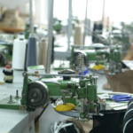 Garment linking machine joining sweater panels in knitting factory workshop