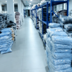 Organized factory warehouse storing semi-finished knit panels and sweater materials